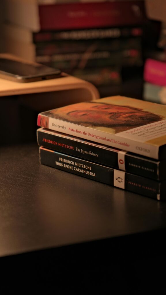 Cozy evening scene with classic philosophy books stacked on a desk.